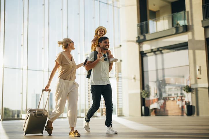 Family with children at the airport heading on holiday