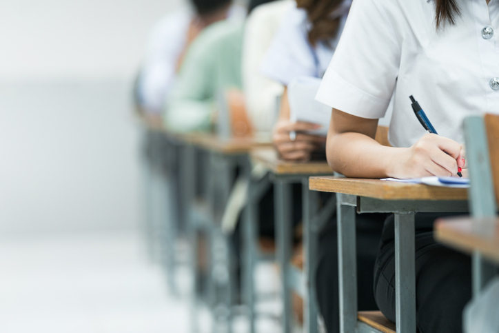 People sitting at table writing